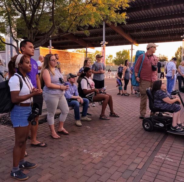 a group of people on a sidewalk