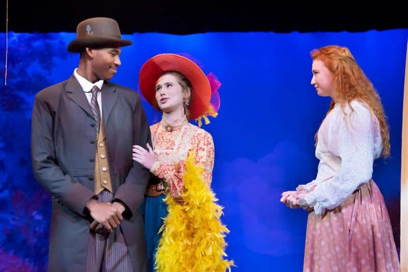 a man wearing a blue dress standing next to a woman a man wearing a blue dress standing next to a woman