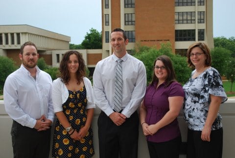 a group of people standing in front of a building