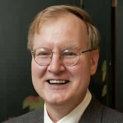 a man wearing glasses and smiling at the camera a man wearing glasses and smiling at the camera