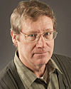 a man wearing glasses and looking at the camera a man wearing glasses and looking at the camera