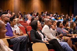 a group of people sitting in front of a crowd