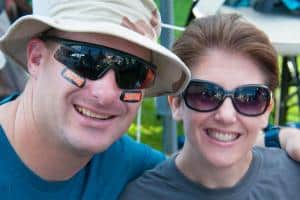 a person wearing sunglasses and smiling a person wearing sunglasses and smiling
