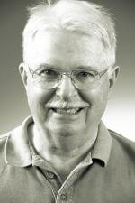 Alan Gribben wearing glasses and smiling at the camera Alan Gribben wearing glasses and smiling at the camera