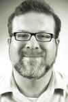 a man wearing glasses and looking at the camera a man wearing glasses and looking at the camera