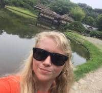 a person wearing sunglasses posing for the camera a person wearing sunglasses posing for the camera