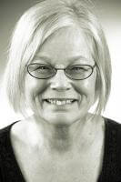 a person wearing glasses and smiling at the camera a person wearing glasses and smiling at the camera