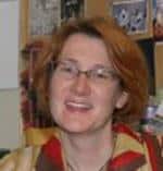 a person wearing glasses and smiling at the camera a person wearing glasses and smiling at the camera