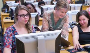 a group of people looking at a computer