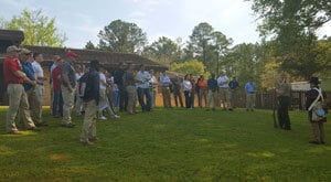 a group of people standing in a field