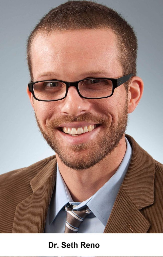 a man wearing glasses posing for the camera