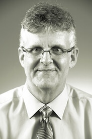 a man wearing glasses and smiling at the camera a man wearing glasses and smiling at the camera