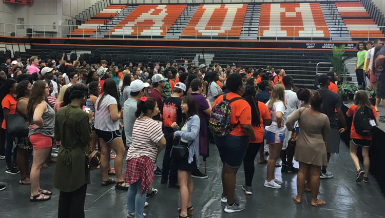 a group of people standing in front of a crowd