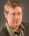a man wearing glasses and looking at the camera a man wearing glasses and looking at the camera