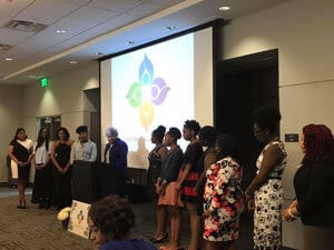 a group of people standing in front of a crowd