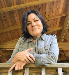 a woman sitting on a wooden bench