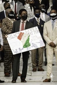 a group of people holding a sign