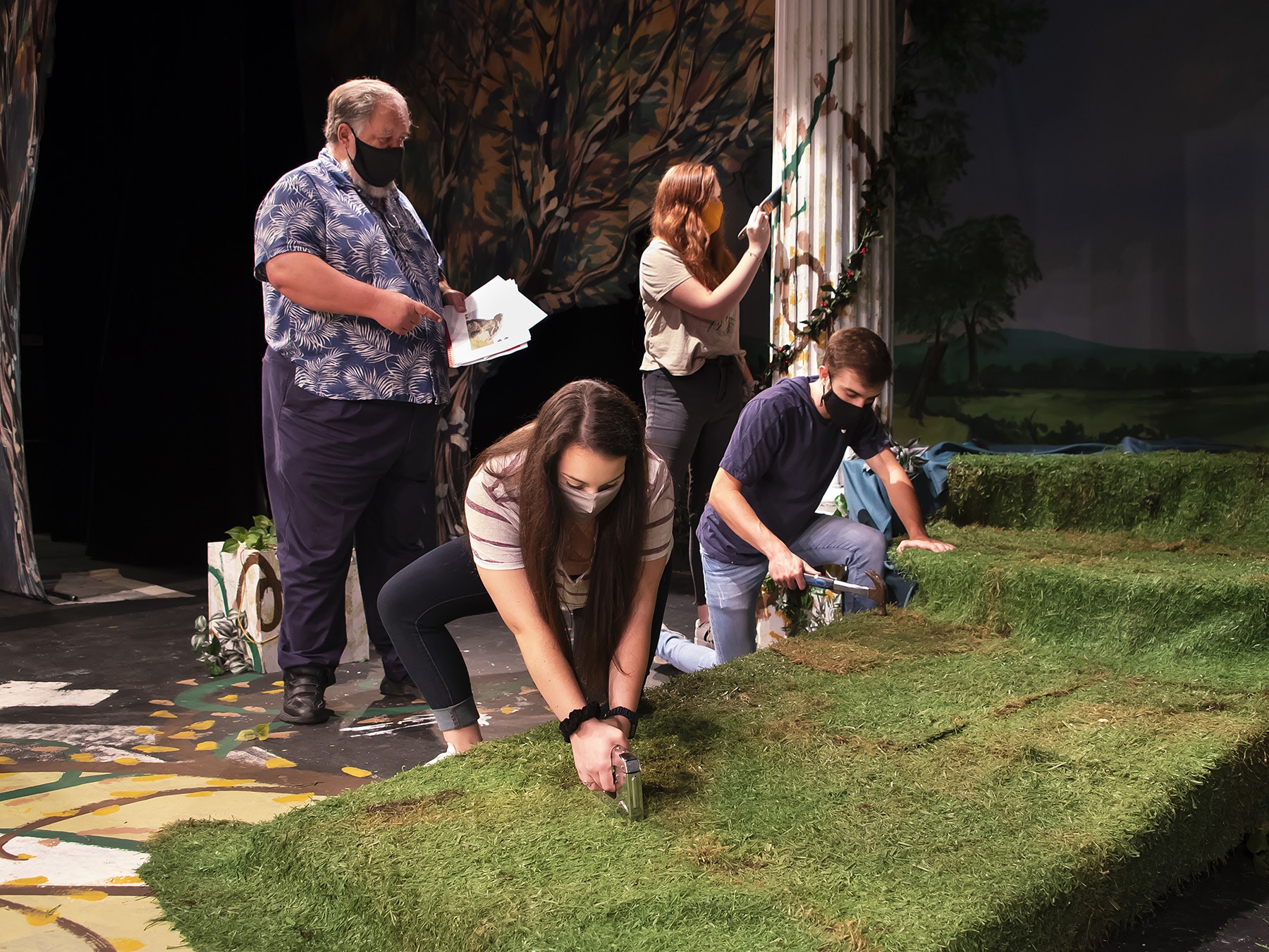 a group of people that are standing in the grass a group of people that are standing in the grass