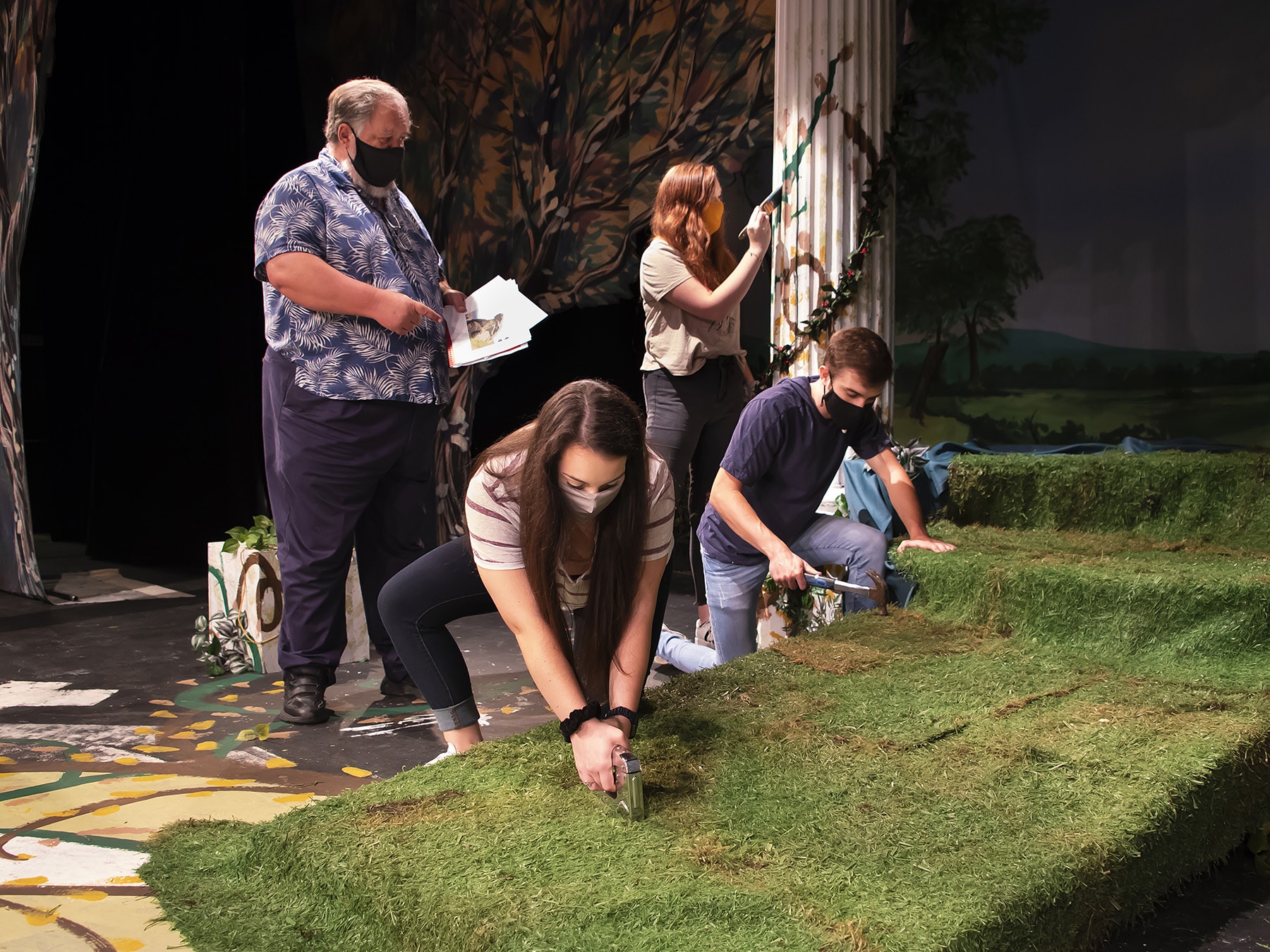 a group of people that are standing in the grass