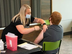Nurse gives a vaccine.
