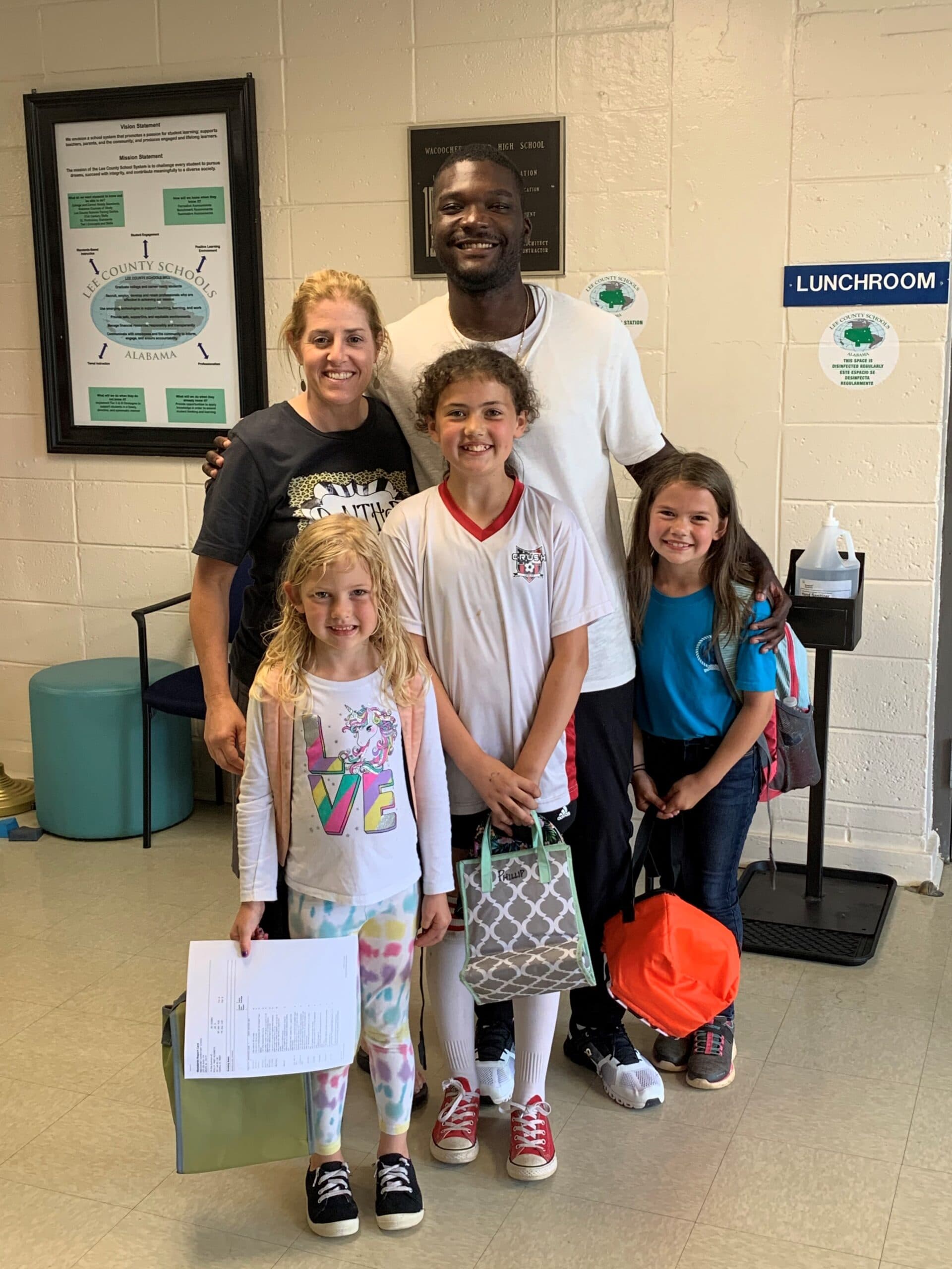 Derrick Harris with elementary school students