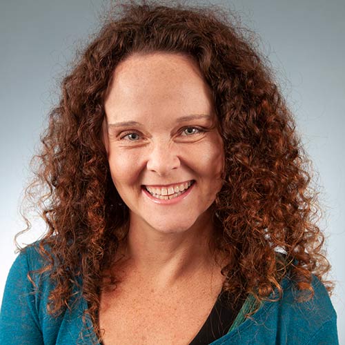 a close up of a woman in a blue shirt