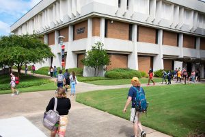 a group of people walking in front of a building