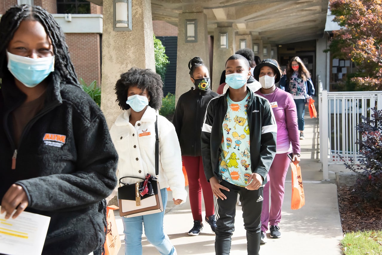 a group of people on a sidewalk