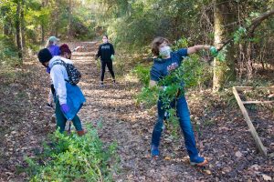 Campus community members help clean up the AUM trails.