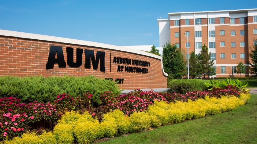 AUM's Front Entrance Sign With Warhawk Hall In The Background.