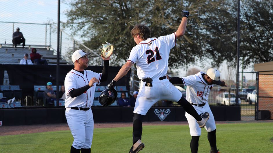 a group of people playing baseball on a field