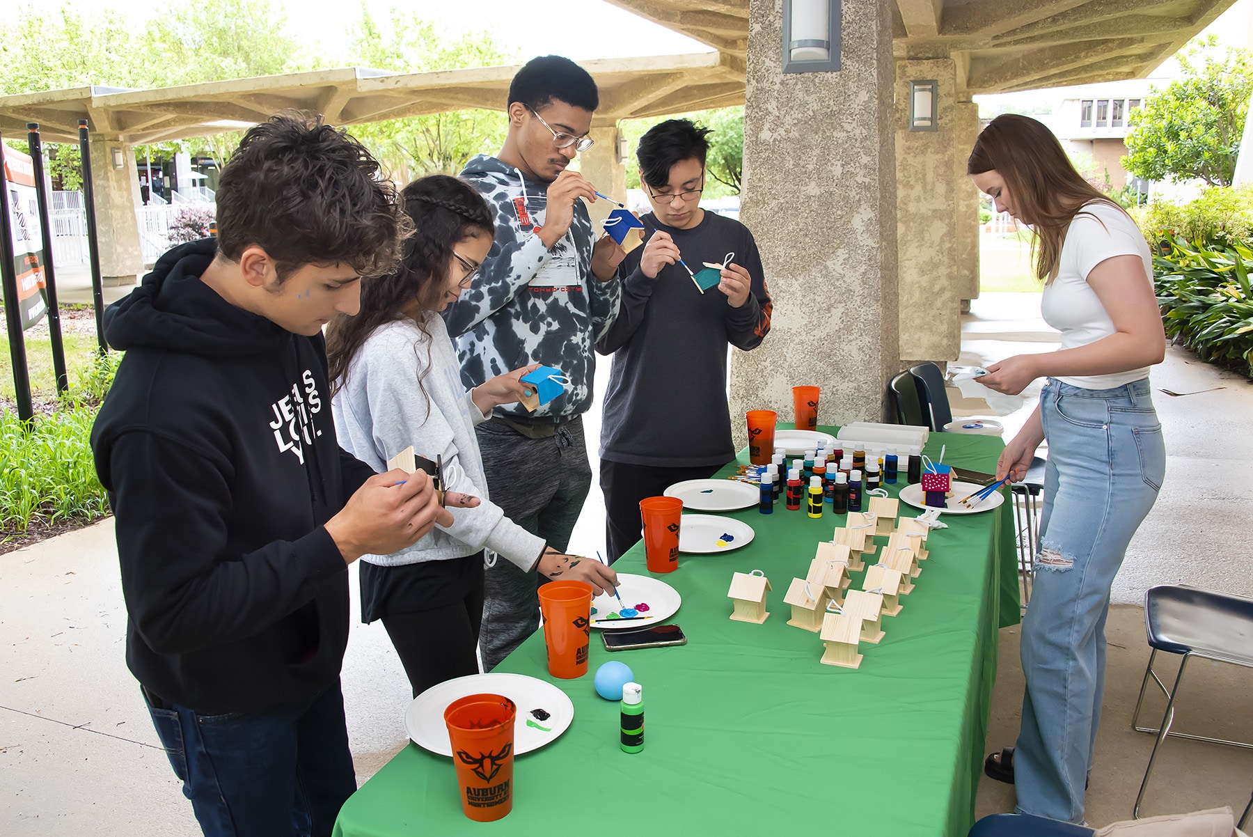 a group of people standing around a table