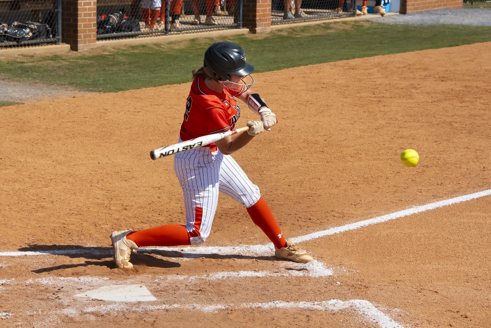 a baseball player swinging a bat at a ball