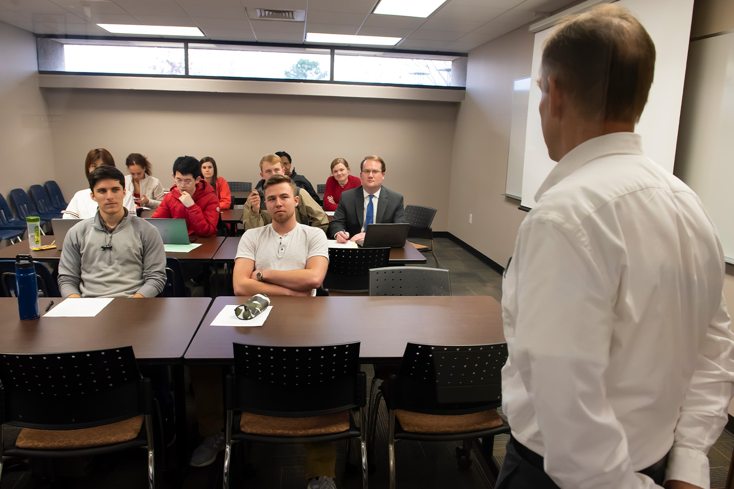 a group of people standing in front of a desk