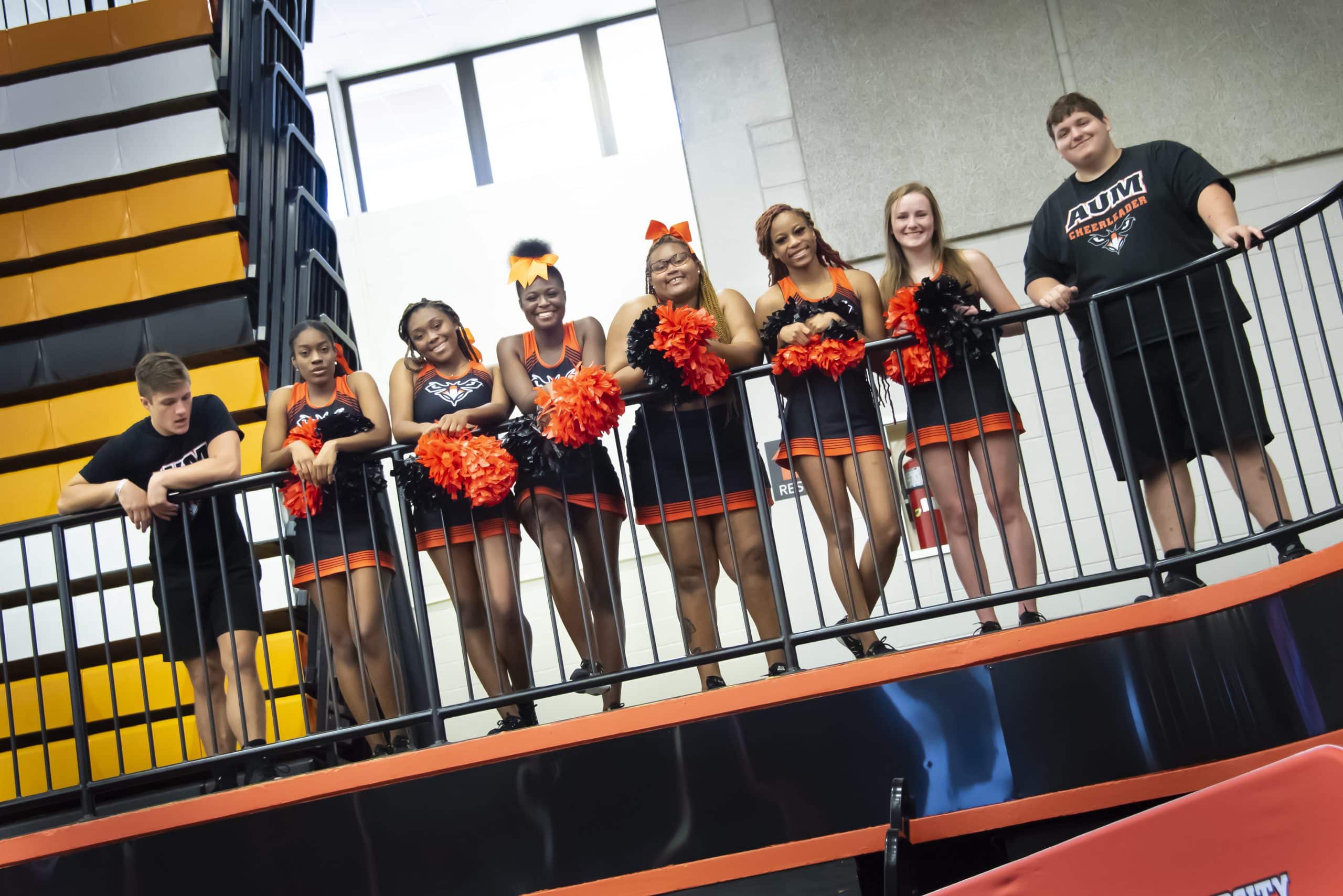 a group of people standing in a cage