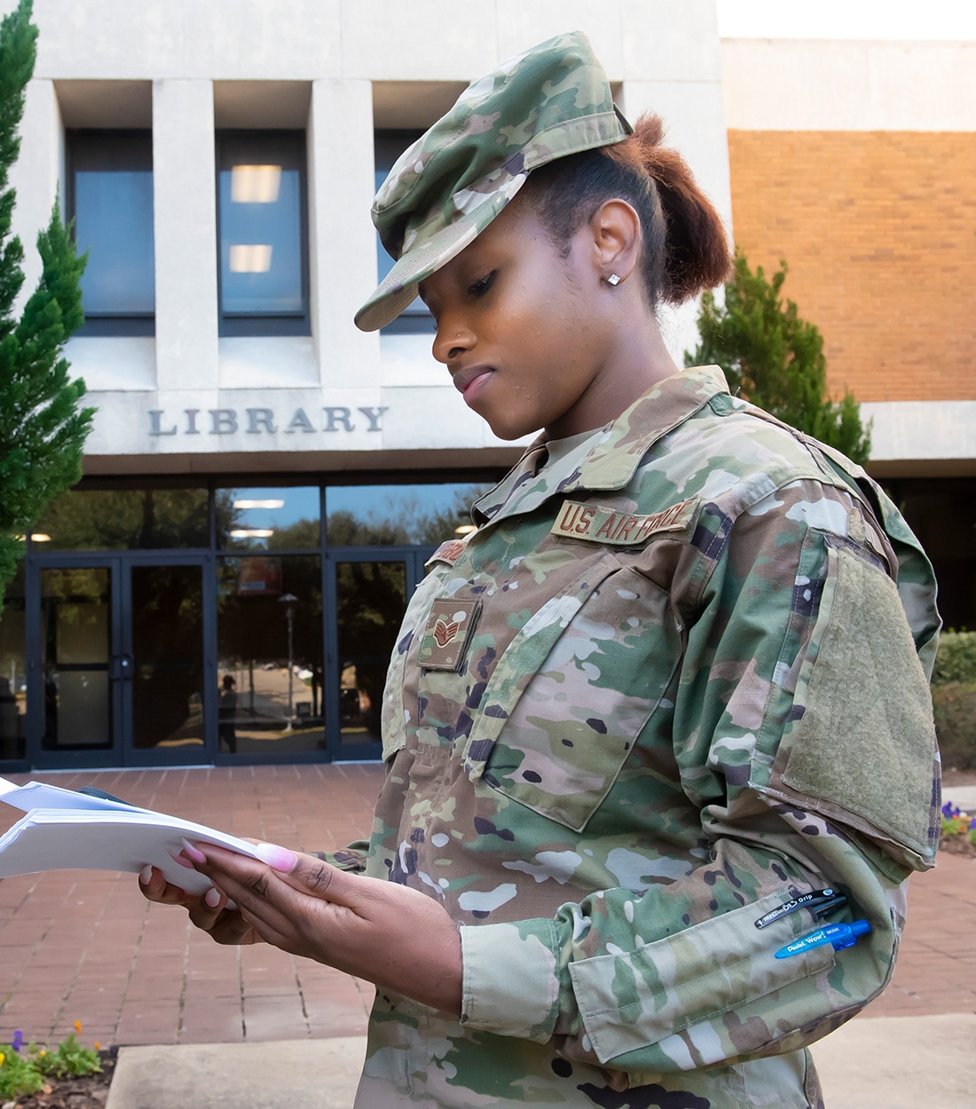 Sgt in camo in front of library