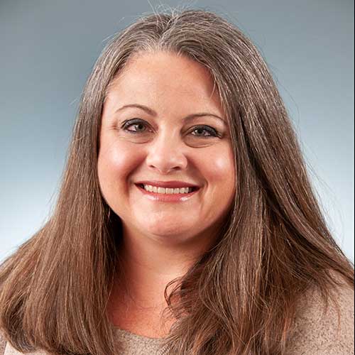 a close up of a woman smiling for the camera