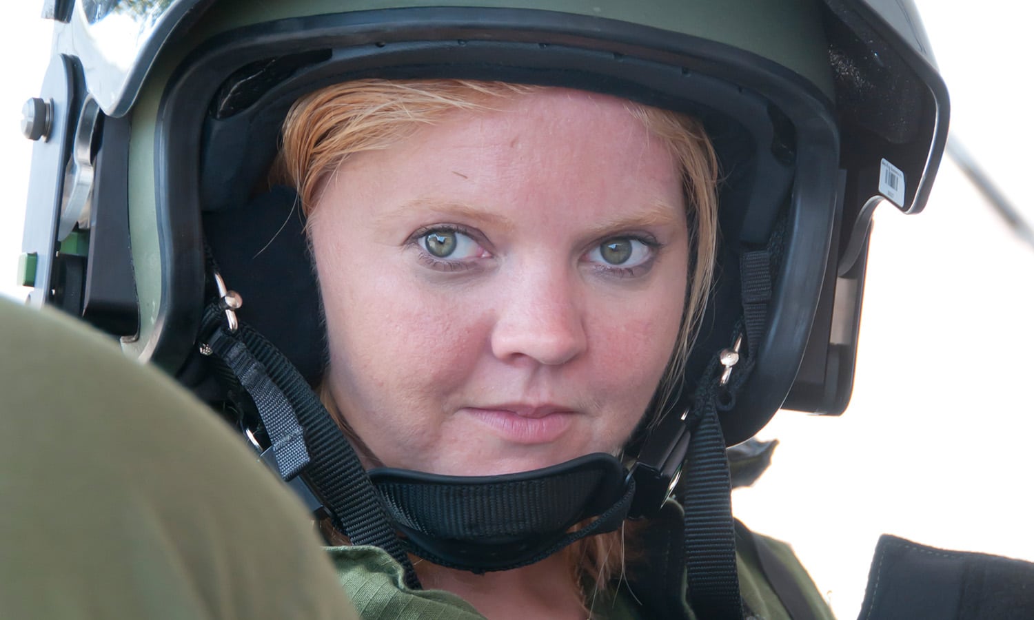 a person wearing a helmet sitting in a car