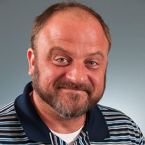 a close up of a man smiling for the camera