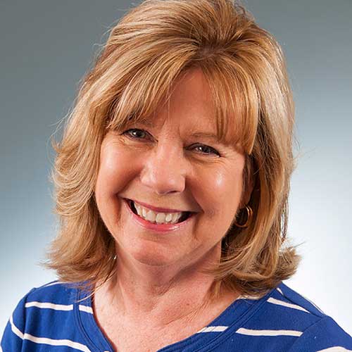 a close up of a woman in a blue shirt