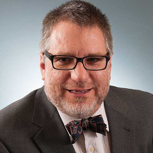 a man wearing glasses and a suit and tie