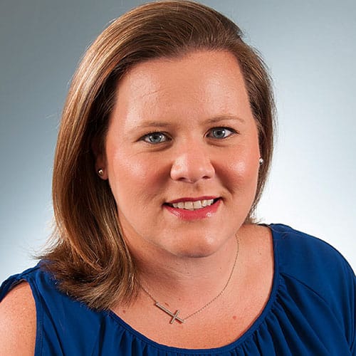 a close up of a woman in a blue shirt