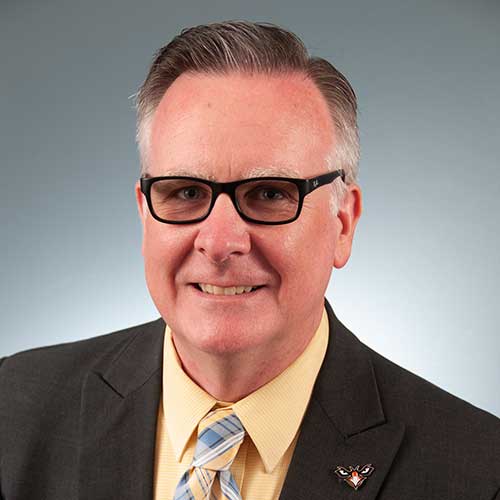 a man wearing glasses and a suit and tie