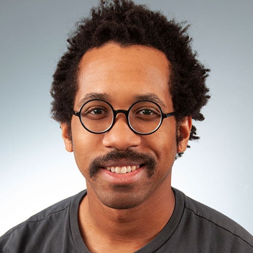 a man wearing glasses and looking at the camera