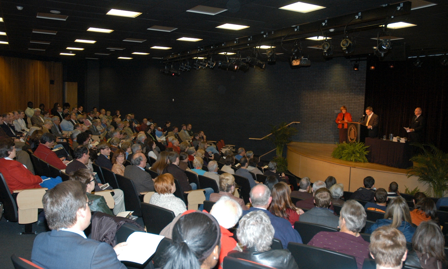 a group of people sitting in front of a crowd