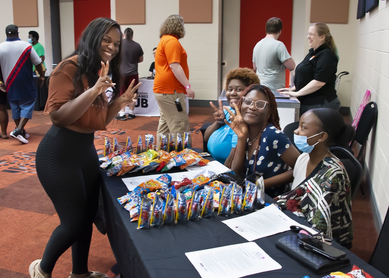 a group of people standing around a table