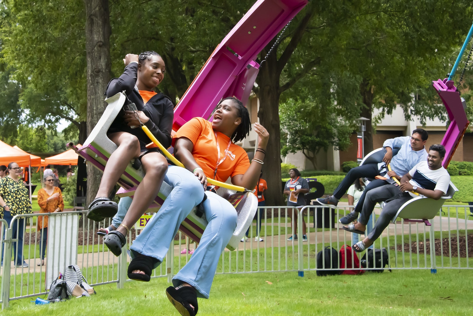 Sidra Smith et al. sitting around a baseball bat on a field