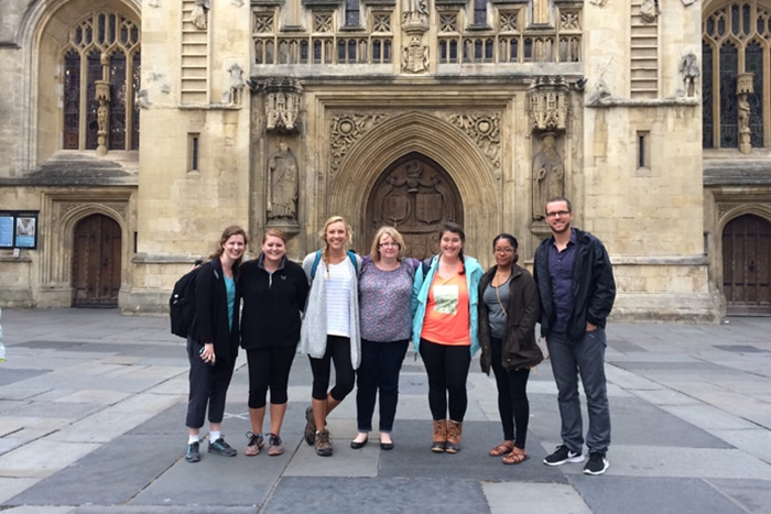 a group of people walking in front of a building