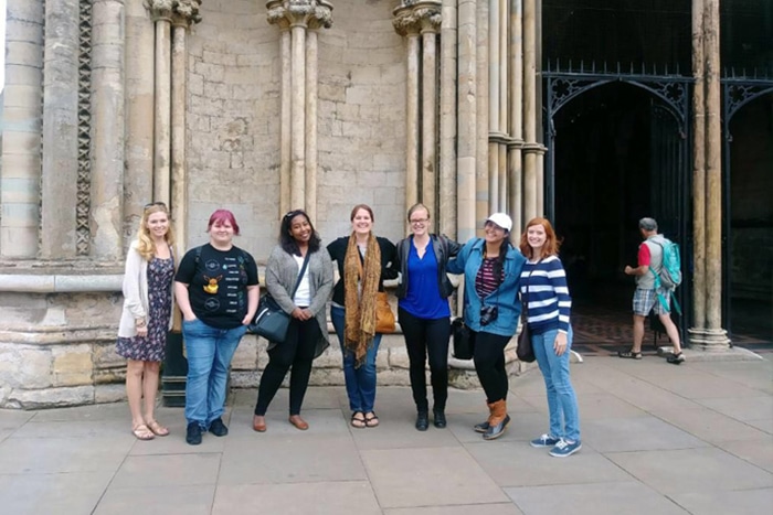 a group of people standing in front of a building