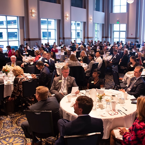 A Large Group Of People Sitting At A Table